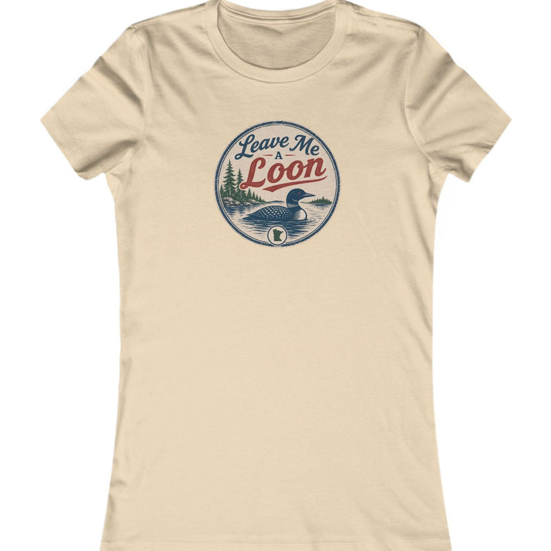 A beige short-sleeve crewneck t-shirt featuring a circular vintage-style graphic on the chest with a loon illustration and the text 'Leave Me Loon'.
