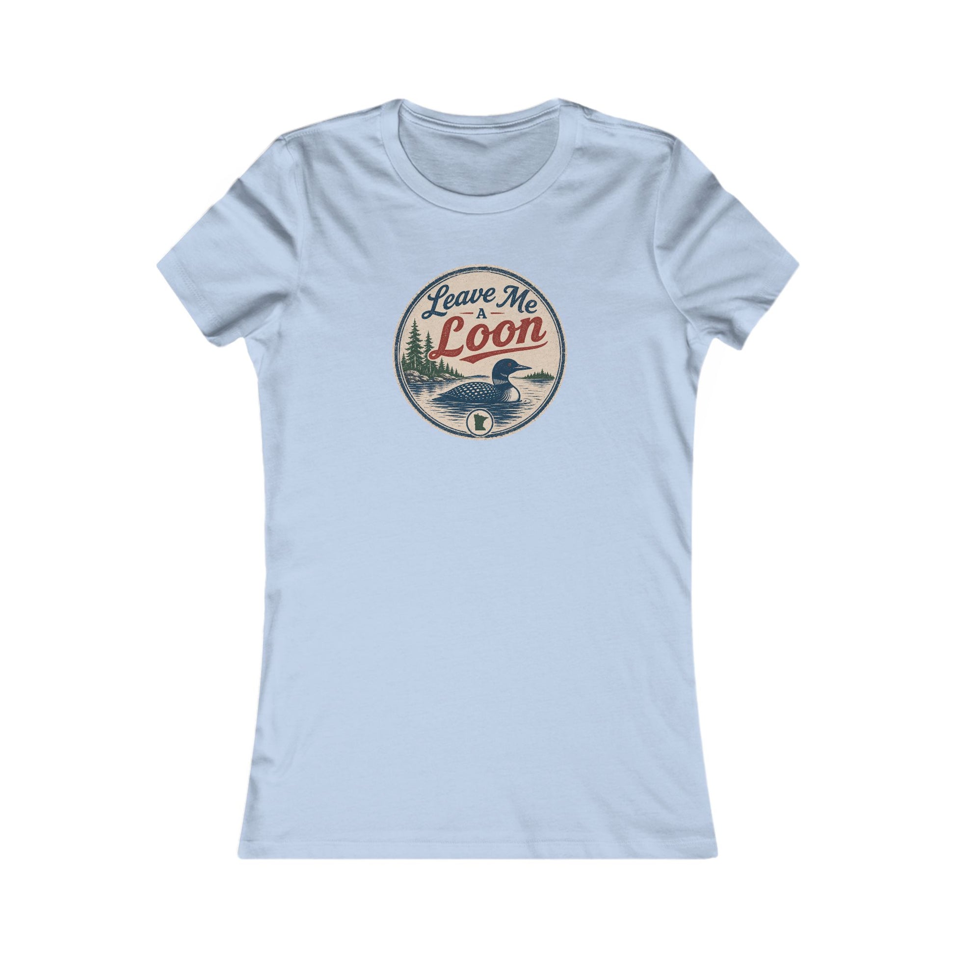 A light blue short-sleeve crewneck t-shirt featuring a circular vintage-style graphic on the chest with a loon duck and the text 'Leave Me Loon'.