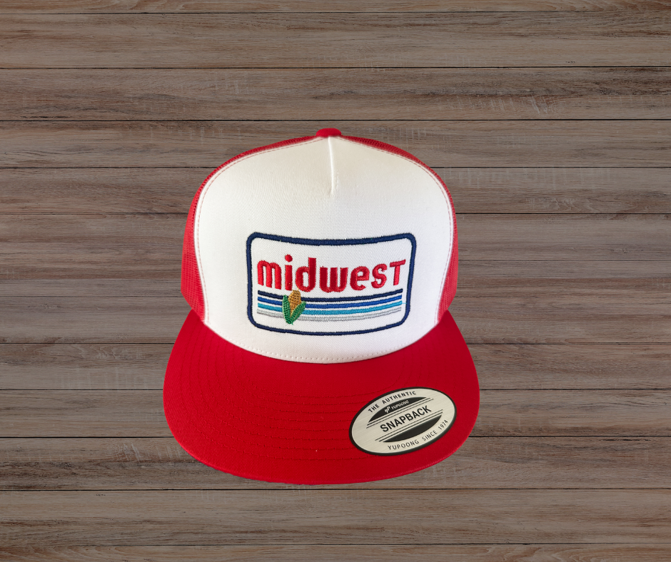 Red and white cap with 'midwest' logo on a wooden background